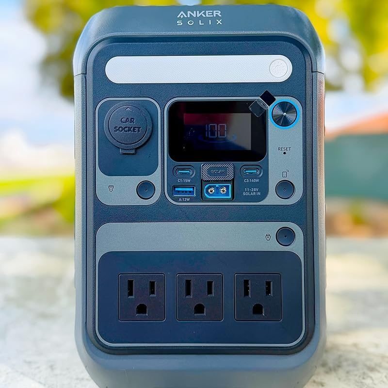 Anker SOLIX C300X portable power station standing in front of its carrying case.
